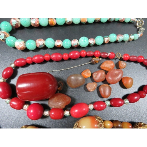 358 - A selection of vintage bead necklaces to include a cherry amber style dropper