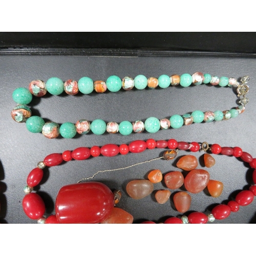 358 - A selection of vintage bead necklaces to include a cherry amber style dropper