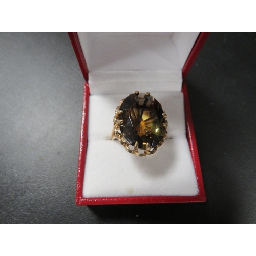 385 - A hallmarked 9 carat gold dress ring set with a smoky quartz approx. weight 7.4g