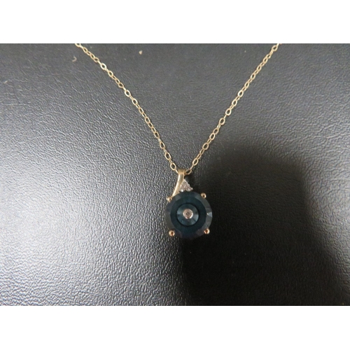 395 - A gem set pendant on a 9kt chain approx. weight 1.8g