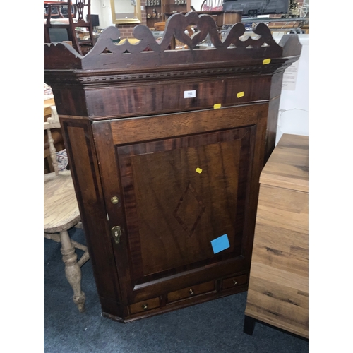 819 - A Georgian oak cross banded corner cupboard together with An antique mahogany inlaid overmantel mirr... 