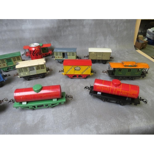 94 - THIRTEEN UNBOXED PIECES OF O GAUGE ROLLING STOCK, comprising three tankers and ten covered wagons