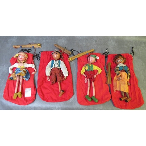 185 - FOUR UNBOXED PELHAM PUPPETS, to include Tyrolean boy / girl and cowboy / girl,  all in red puppet ba... 