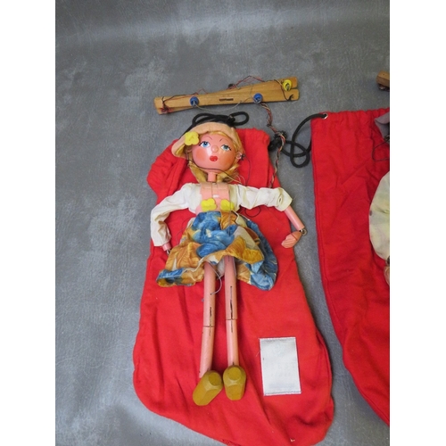 185 - FOUR UNBOXED PELHAM PUPPETS, to include Tyrolean boy / girl and cowboy / girl,  all in red puppet ba... 