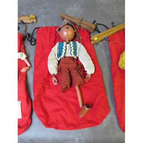 185 - FOUR UNBOXED PELHAM PUPPETS, to include Tyrolean boy / girl and cowboy / girl,  all in red puppet ba... 