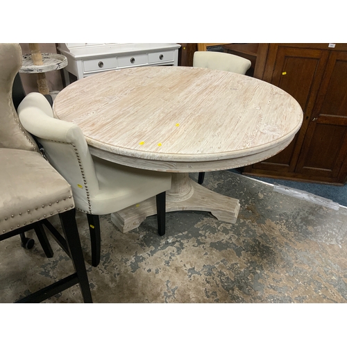 814 - A large modern limed circular pedestal dining table Dia. 140 cm together with two chairs