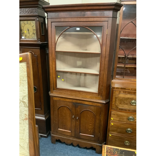 822 - An antique oak glazed floor standing corner cabinet H 210 cm