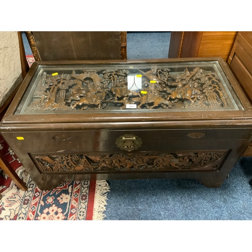 875 - An eastern carved glass topped coffer W 93 cm