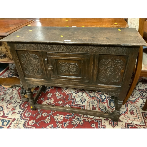 878 - An antique carved oak cabinet with single door W 92 cm