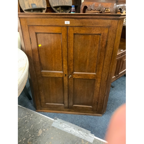 884 - A Georgian oak corner cupboard