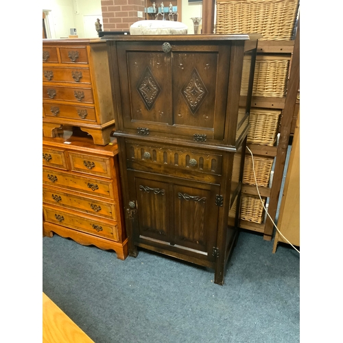 891 - A small oak carved drinks cabinet W 64 cm