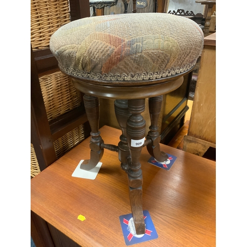 908 - An antique mahogany revolving piano stool