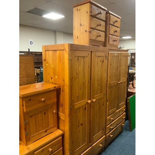 910 - Two honey pine wardrobes together with three honey pine bedside chests