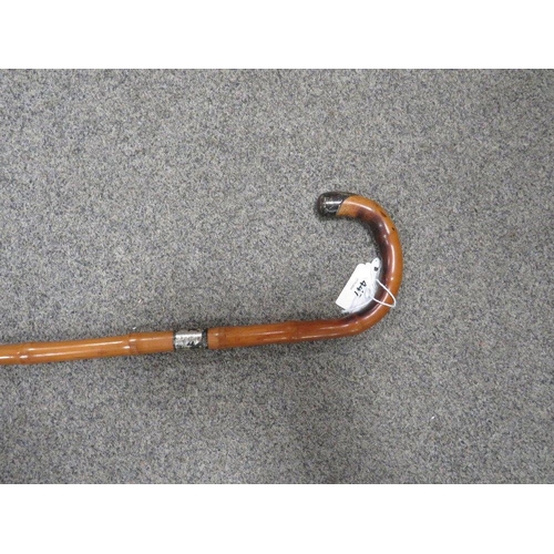 447 - A hallmarked silver topped walking cane together with a silver topped bamboo example