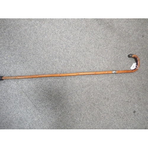 447 - A hallmarked silver topped walking cane together with a silver topped bamboo example