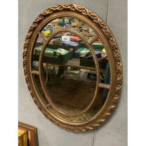 228 - A modern oval gilt sectional mirror