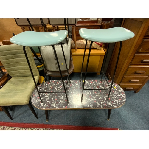 786 - A mid century oval formica topped coffee table together with two stools