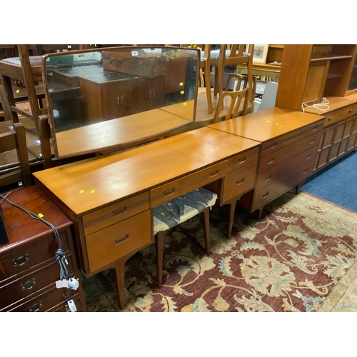 796 - A mid century ‘Butilux’ teak dressing table, stool and four drawer chest (2)