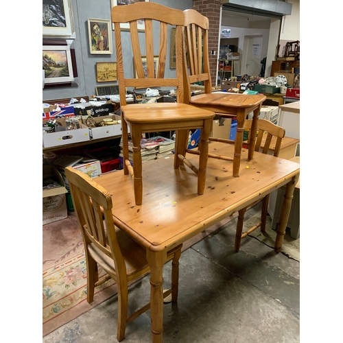 810 - A honey pine kitchen table and four chairs