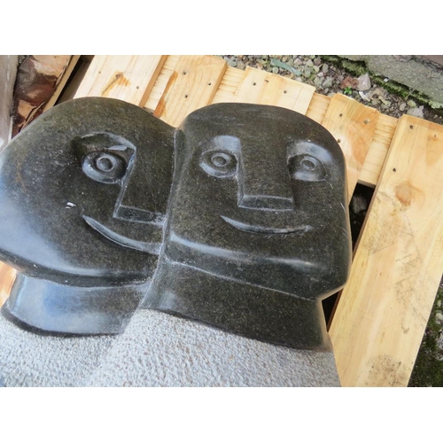 665 - A large stone type statue of two tribal figures signed 'DAVIDSON CHAKAWA' - H 100 cm, W 50 cm