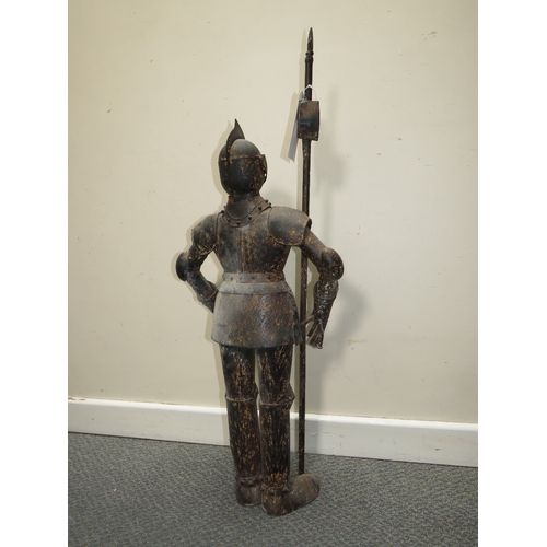 27 - A DECORATIVE METAL FIGURE OF A STANDING KNIGHT IN ARMOUR HOLDING A POLE ARM, H 89 cm