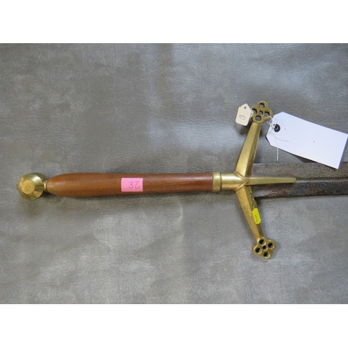 28 - A REPLICA MEDIEVAL TWO HANDED SWORD, turned wood grip, brass pommel and brass cross guard, with quat... 