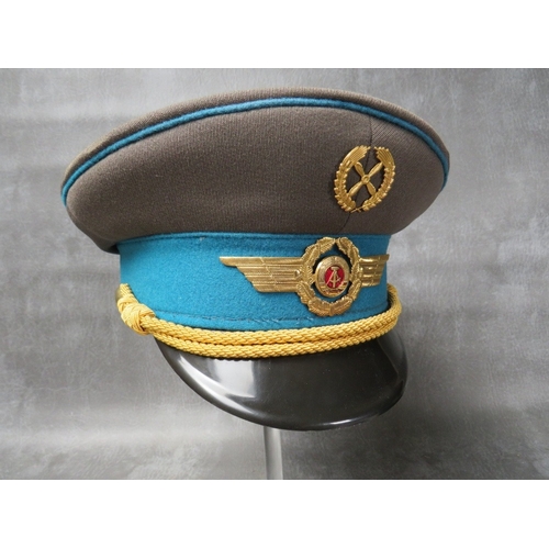 35 - THREE EAST GERMAN (GDR) OFFICERS CAPS, with gilt badges and bullion thread type bands (3)