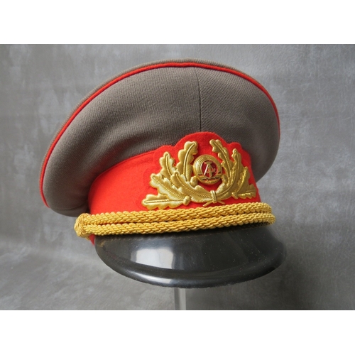 35 - THREE EAST GERMAN (GDR) OFFICERS CAPS, with gilt badges and bullion thread type bands (3)