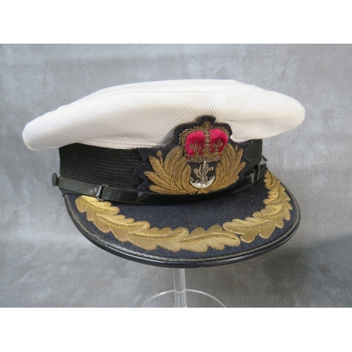 37 - THREE ROYAL NAVY CAPS, consisting of two officers types with Queens crown badges and a seaman's with... 