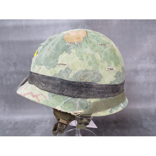 67 - A US WW2 M1 HELMET (FRONT SEAM), with 1961 Air Borne liner, with camo cover