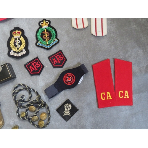 175 - A BOX OF ASSORTED CLOTH AND OTHER BADGES, to include Communist types, along with a GDR armband, a 19... 