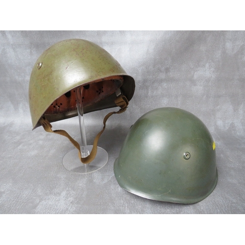 61 - TWO ITALIAN WW2 TYPE GREEN PAINTED TIN HELMETS, with leather liners (2)