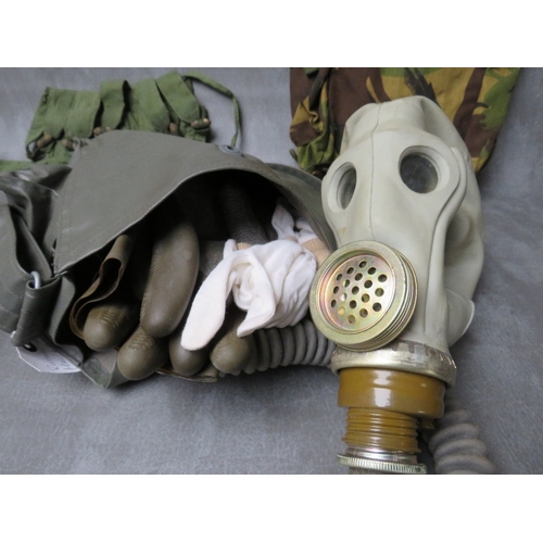 64 - THREE ASSORTED GAS MASKS, a British example date 1954, a Russian type with gloves in pouch dated 198... 