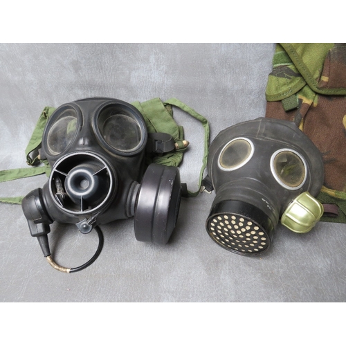 64 - THREE ASSORTED GAS MASKS, a British example date 1954, a Russian type with gloves in pouch dated 198... 