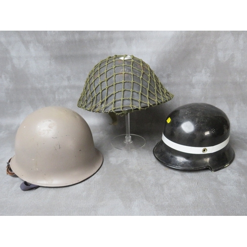 66 - A BRITISH TURTLE TYPE TIN HELMET, (1952 by Rubry Owen), together with a French helmet dated 1964 (wi... 