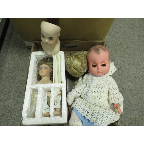 115 - A large box of porcelain dolls and dolls parts etc