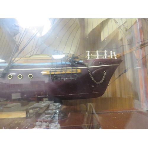 79 - A model of a tall sail ship in a bespoke glass display case