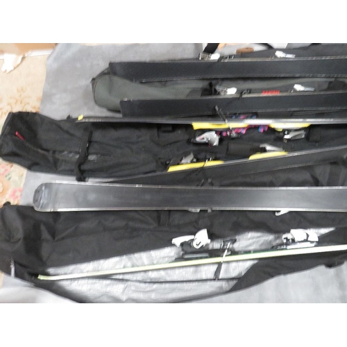 133 - Three pairs of skis with carry bags