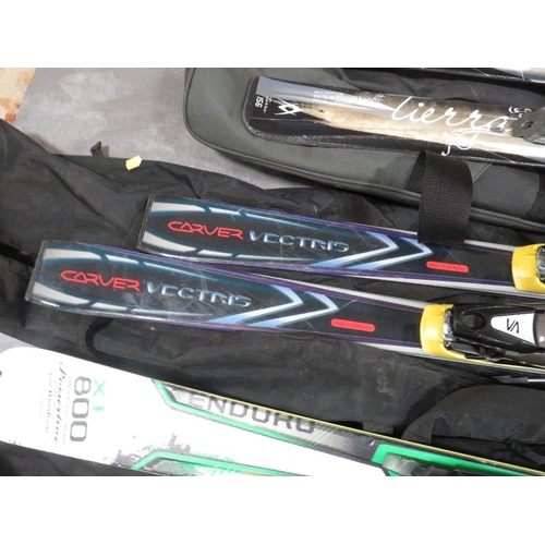 133 - Three pairs of skis with carry bags