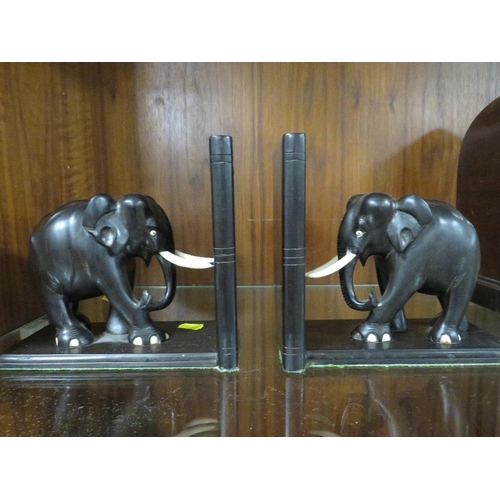 239 - A pair of carved wooden bookends