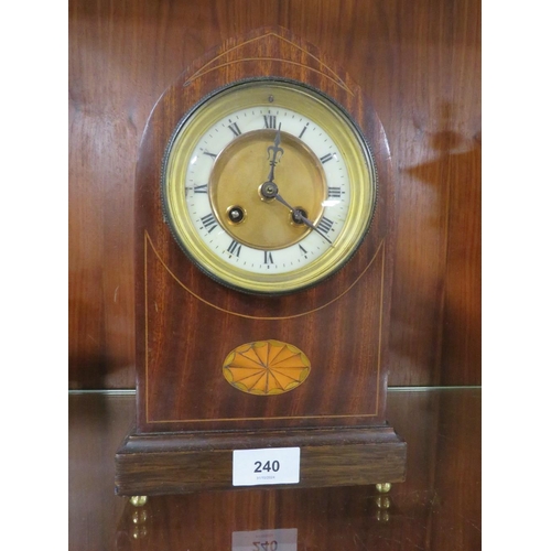 240 - An inlaid domed mantle clock on four brass bun feet