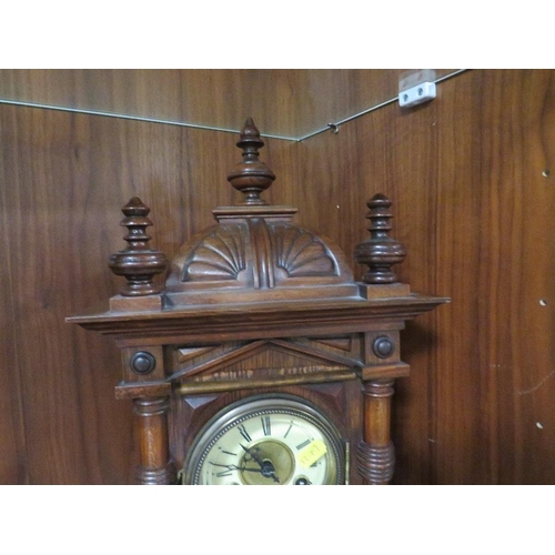 241 - A carved wooden mantle clock with Junghans bell strike movement