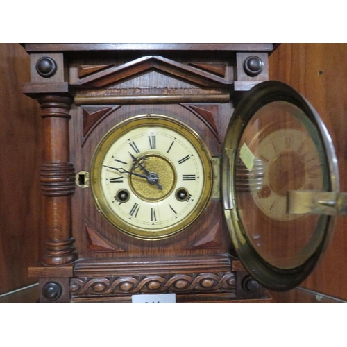 241 - A carved wooden mantle clock with Junghans bell strike movement