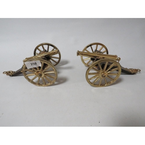 250 - A pair of modern brass and wood desk cannons