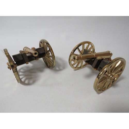 250 - A pair of modern brass and wood desk cannons