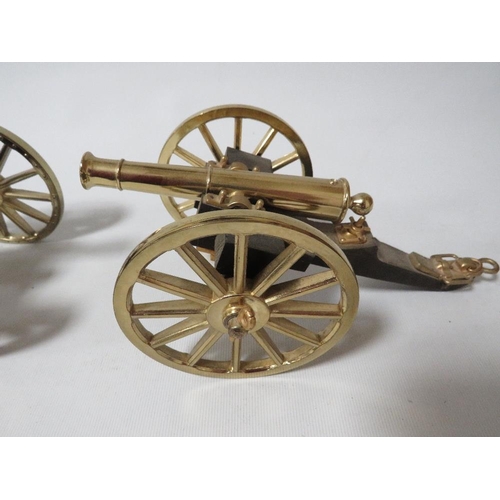 250 - A pair of modern brass and wood desk cannons