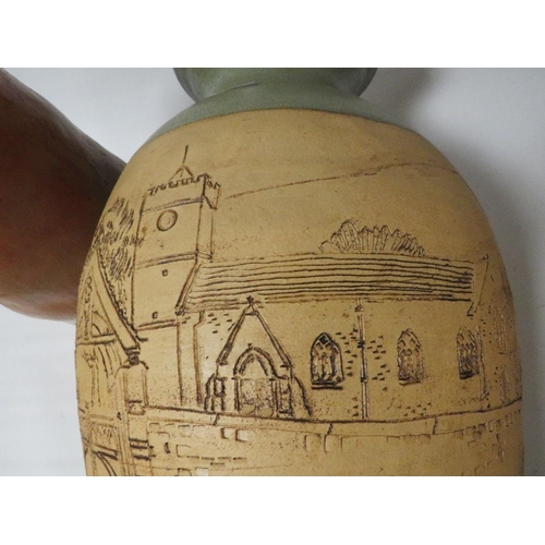 252 - A large studio vase decorated with a street scene signed to base Therese Jones & Alan Tucker togethe... 