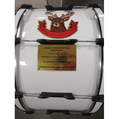 255 - A base drum together with a side snare drum, a snare drum skin and a drum harness