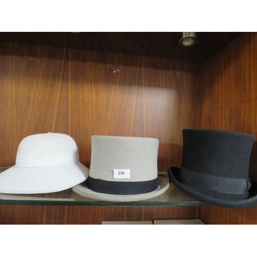 256 - A 100% hand-made black silk lined top hat size L together with a used grey example and a pithed hat ... 