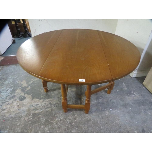 814 - A modern oak finish round dropleaf gateleg dining table